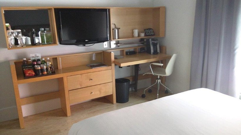 A multi-purpose console occupies one bedroom wall