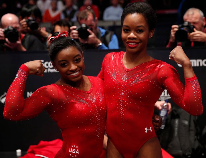 Gold medalist Simone Biles, left, celebrates with silver medalist Gabrielle Douglas after the women's all-round final at the World Gymnastics Championships in Scotland in October 2015.