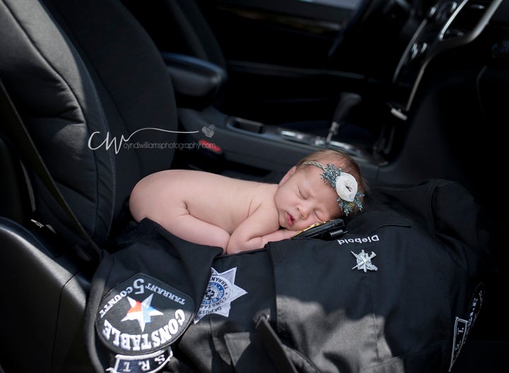 Evelyn posed with the officer's uniform in the front seat of her parents' car -- the exact spot where she was born.