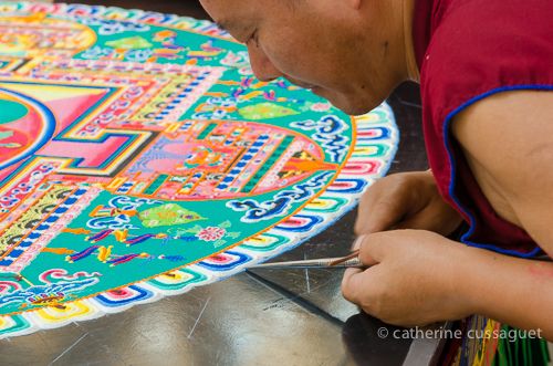 Tibetan monks drawing a sand mandala