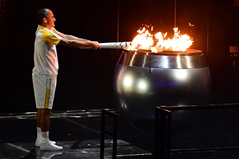 Former Brazilian athlete Vanderlei Cordeiro lights the Olympic cauldron with the Olympic torch during the opening ceremony of