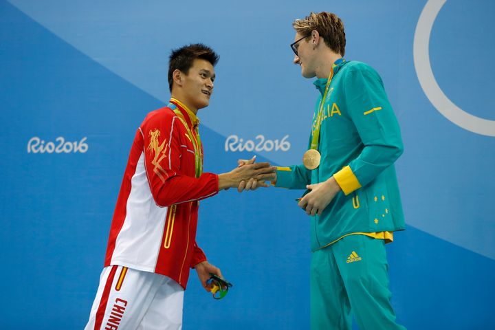 In a more civil moment, 400 meter freestyle gold medalist Mack Horton of Australia shakes hands with silver medalist Yang Sun of China during the medal ceremony.
