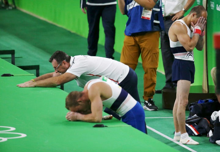 Members of the French team react in horror