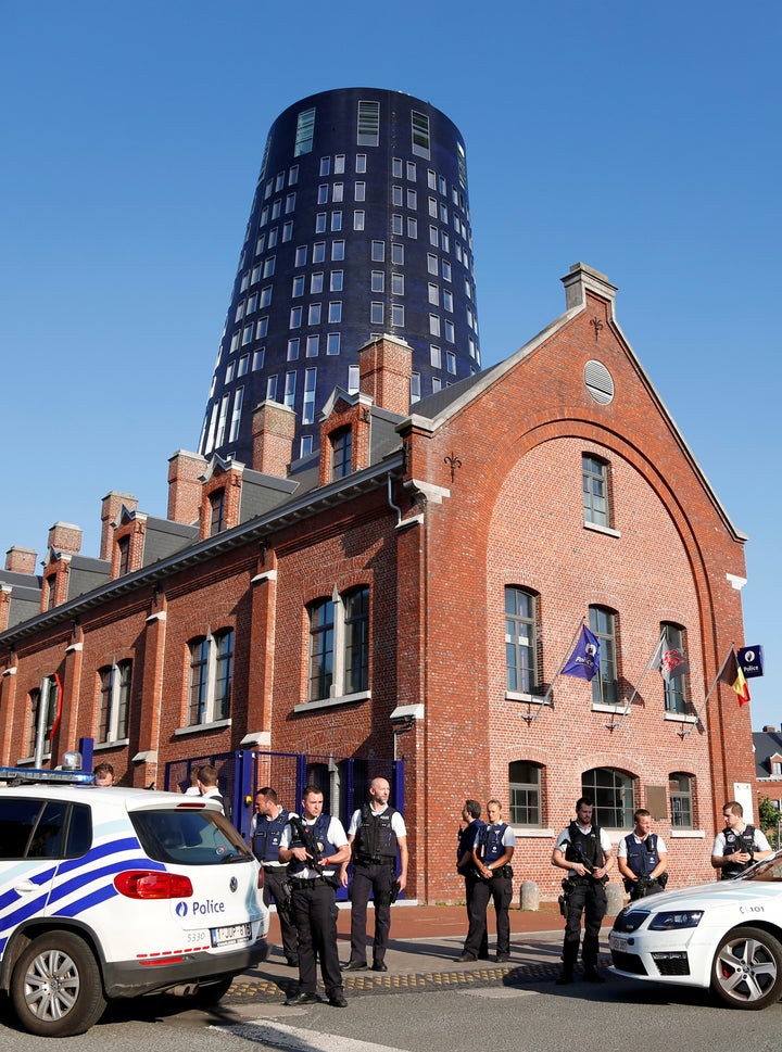 Belgian police officers secure the entrance of the main police station