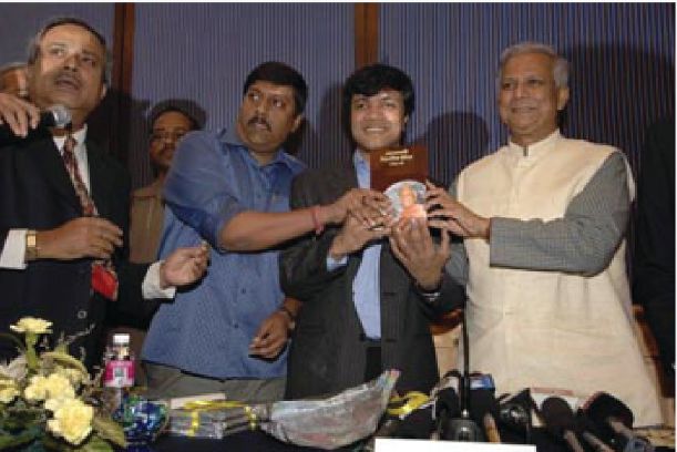 Yunus leads a ceremony unveiling Rashidul Bari's new book, Grameen Social Business Model, on February 14, 2007, at the Park Hotel in India. The book, which was published by Pradip Kumar Saha, details how Yunus developed the concept of microcredit & social business.