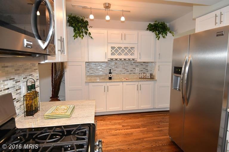 Same kitchen as above, opposite wall space made into additional cabinet and storage space.
