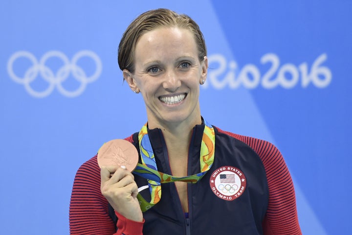 Dana Vollmer poses on the podium after she won bronze in the Women's 100m Butterfly Final during the swimming event at the Rio 2016 Olympic Games.