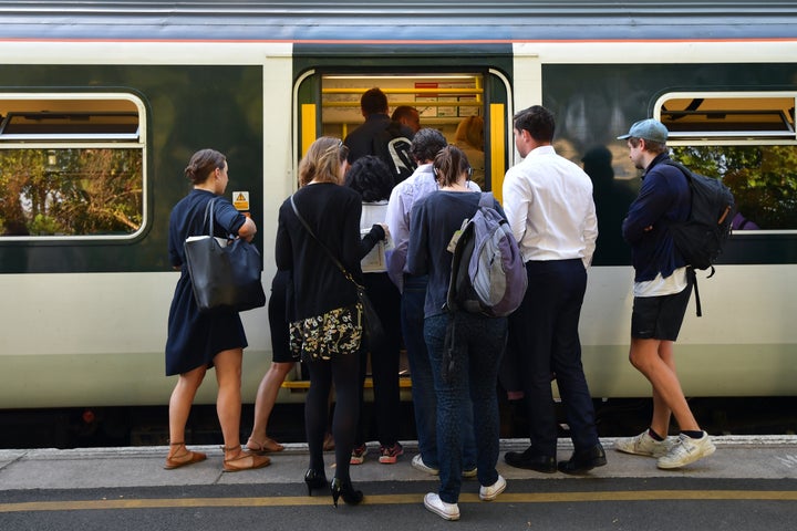 <strong>People line up to board a Southern rail service train at East Dulwich</strong>