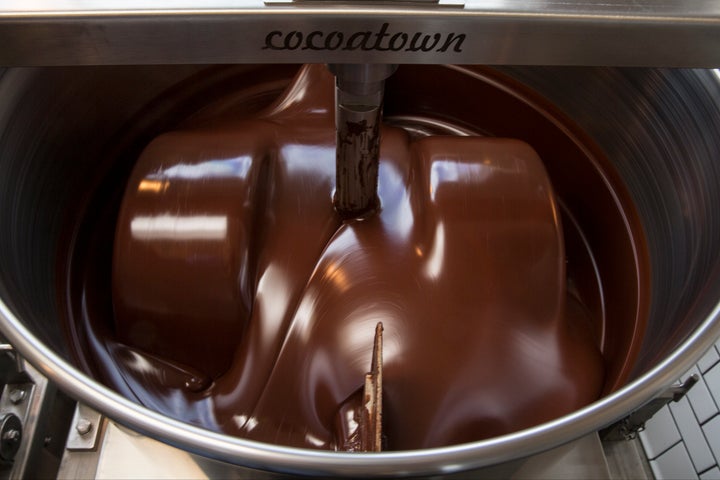 Mixing cocoa and sugar to be made into chocolate.