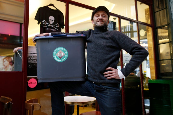 Stephan Martinez, owner of Le Petit Choiseuil bistrot, poses with a garbage container to collect food waste in Paris February 12, 2014. A group of Paris restaurants is turning food scraps into biogas and compost ahead of a new law that will force thousands of French food outlets to recycle their organic waste. Some 80 restaurants, caterers and hotels, signed up for a pilot project to collect their food waste, which is used to generate biogas and produce electricity and heat, as well as compost for farms around Paris. Martinez, who took the initiative for the project, said the collection anticipates the law but that participating restaurants are happy that someone collects their waste and puts it to good use. REUTERS/Charles Platiau