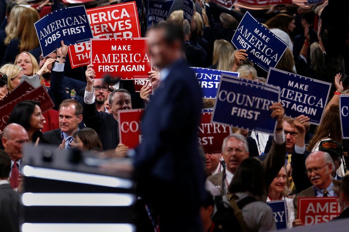 People wave placards during senator Ted Cruz's speech at the Republican National Convention in Cleveland.