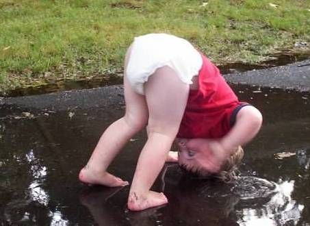 <em>My oldest back in 2003, putting his head into a rain puddle. Because...of course.</em>