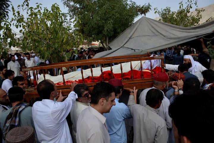 Relatives of suicide attack victims carry coffins during a funeral ceremony in Quetta, the provincial capital of Balochistan,