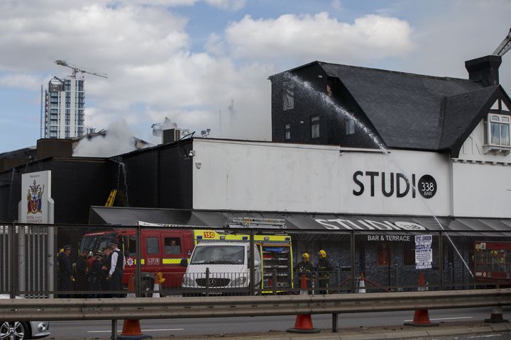 Fire brigade crew work to extinguish the fire at London nightclub 'Studio 338' on Monday.
