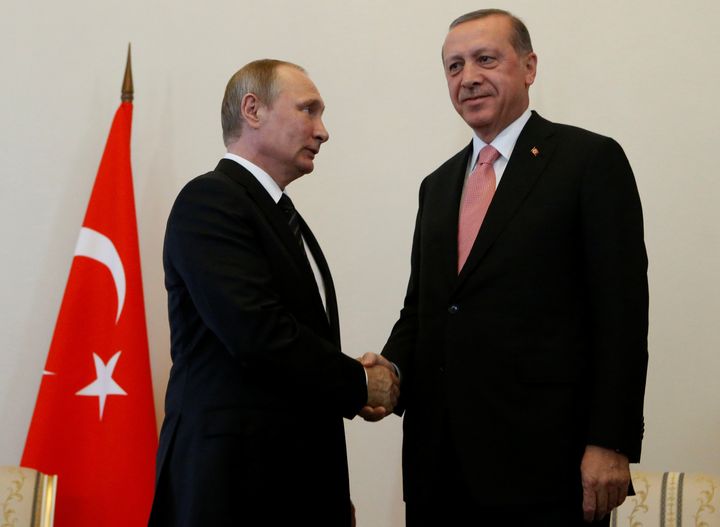 Russian President Vladimir Putin shakes hands with Turkish President Tayyip Erdogan during their meeting in St. Petersburg, Russia, August 9, 2016