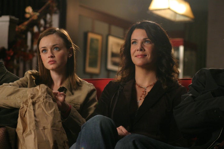 Medium shot of Alexis Bledel as Rory sitting on couch with Lauren Graham as Lorelai.