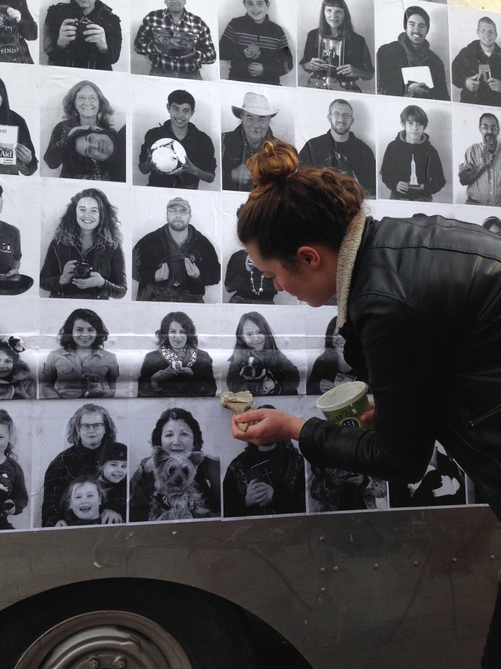 Wheat-pasting a portrait to the exterior of the Axle Contemporary van in Albuquerque.