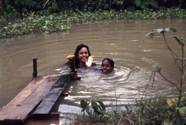 The morning following our arrival at a remote village in Bangladesh, our hosts take a swim near their house to cool off.