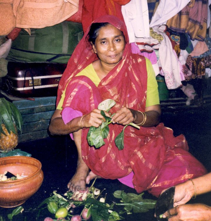 Kangalini Sufia -- friend and research interlocutor -- preparing food in her apartment in Dhaka, Bangladesh. One of the most famous performers of folk Baul songs in Bangladesh, Kangalini supports a group of about twelve people, including family and other musicians.