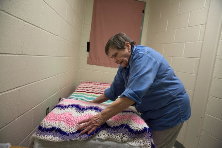 At Maine Correctional Center, Norma, 76, makes her bed in what used to be a closet. Norma requested that she be separated from the younger female prisoners, who, she says, are too loud and give her anxiety. A fellow inmate made the blanket for her.