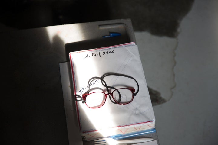 In Albert's cell, notes and pieces of writing are everywhere. He once spent ten years in solitary confinement, which he says he got through by reading, writing, and designing a house.