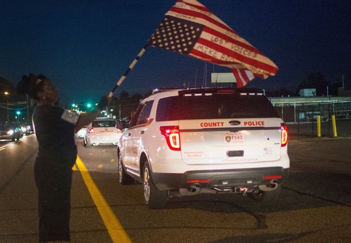 Demonstrators march to mark the first anniversary of the death of Michael Brown on August 7, 2015, in Ferguson, Missouri.