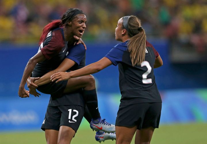 Crystal Dunn (left) and Mallory Pugh (2) celebrate Dunn's first-half goal against Colombia. Dunn and Pugh each scored their first career Olympic goals in the match.