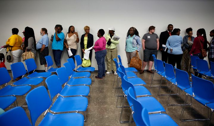 People line up for the chance to speak to representatives from the Department of Justice during a meeting held to talk about the agency's investigation of the Ferguson police department Wednesday, Sept. 24, 2014, in Ferguson, Mo