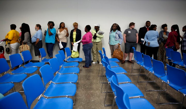 People line up for the chance to speak to representatives from the Department of Justice during a meeting held to talk about the agency's investigation of the Ferguson police department Wednesday, Sept. 24, 2014, in Ferguson, Mo