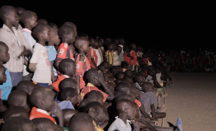 Children at the Kakuma camp cheer on their team