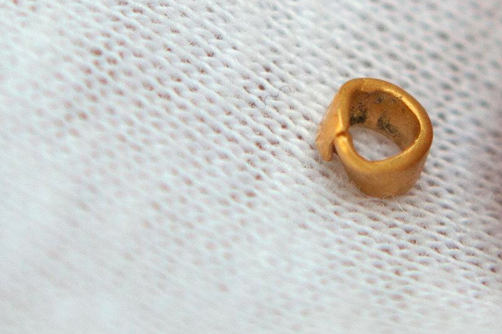 A 15-centigrams gold bead is pictured in village of Yunatsite, Bulgaria, August 8, 2016.