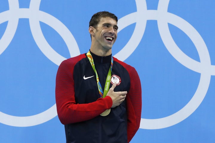 USA's Michael Phelps laughs on the podium with his gold medal at the Rio 2016 Olympic Games on Tuesday.