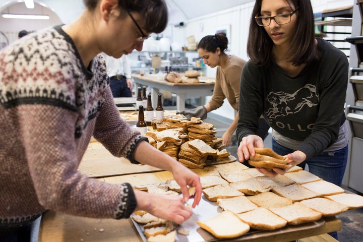 Scrap bread is toasted and broken into smaller pieces before it is used in the brewing process.