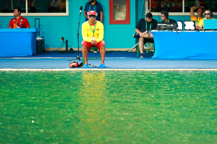 A lifeguard sits by the edge of the diving pool on Day 4 of the Rio 2016 Olympic Games.