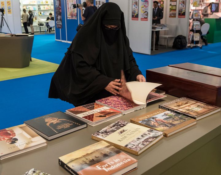 A niqab wearing visitor browses books in Indonesia stand at the the 67th Frankfurt Book Fair, in Frankfurt, Germany, 14 October 2015.