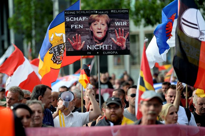 Demonstrators gather in front of a railway station under the banner 'We for Berlin - We for Germany' to protest against German Chancellor Angela Merkel's refugee policy on July 30, 2016, in Berlin, Germany.