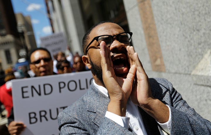 Melech Thomas chants during a demonstration outside the State Attorney's office calling for the investigation into the death of Freddie Gray on April 29, 2015, in Baltimore.