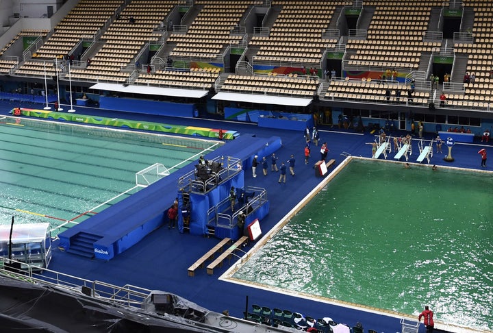 The Olympic water polo pool, at left, began turning green Wednesday.