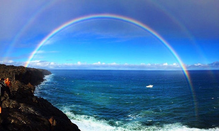 A rainbow formed over the ocean while Teal was paddling to the lava, as her parents watched from the cliffs above.