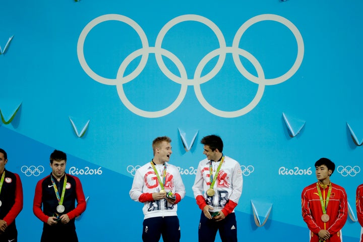 Britain's Jack Laugher, centre left, and Chris Mears, center right, react after being presented with their gold medals.