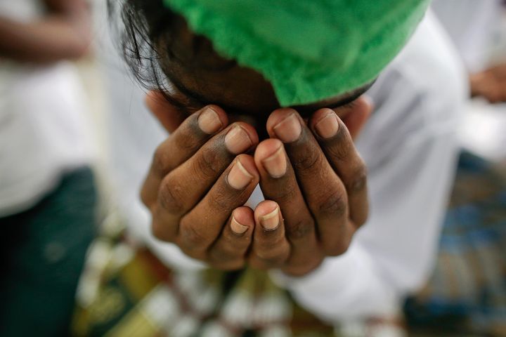 A suspected victim of human trafficking prays at a government shelter in Takua Pa district of Phang Nga October 17, 2014. To match Special Report THAILAND-TRAFFICKING/ Picture taken October 17, 2014. REUTERS/Athit Perawongmetha