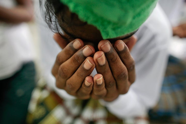 A suspected victim of human trafficking prays at a government shelter in Takua Pa district of Phang Nga October 17, 2014. To