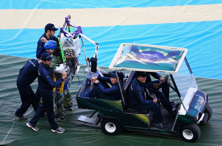 Juliano Pinto is helped onto the field during the opening ceremony of the 2014 FIFA World Cup in Sao Paulo, Brazil. 