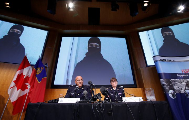An image of Aaron Driver, a Canadian man killed by police on Wednesday who had indicated he planned to carry out an imminent rush-hour attack on a major Canadian city, is projected on screens during a news conference with Royal Canadian Mounted Police (RCMP) Deputy Commissioner Mike Cabana (L) and Assistant Commissioner Jennifer Strachan in Ottawa, Ontario, Canada, August 11, 2016.