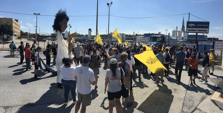 Protesters, including Laura Cáceres and a delegation from Honduras, call for the closing of a refinery in South Philadelphia.