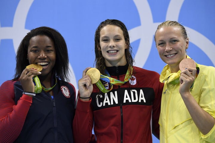 Simone Manuel, Penny Oleksiak and Sarah Sjostrom with their medals for the 100 meter freestyle.