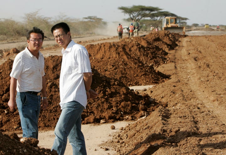 A road construction project manager with China Wuyi Company talks to a colleague at a site near Isiolo town, about 320 km north of Kenyan capital Nairobi, in this 2008 file photo.