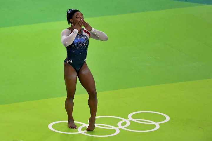 Simone Biles signals to the crowd after winning the gold medal in the women's individual all around final on Thursday.