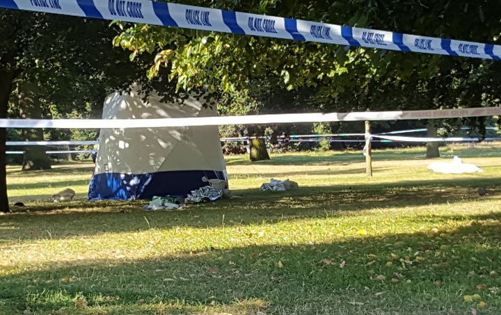 Witnesses described seeing a body lying face down between two trees near a public toilet.