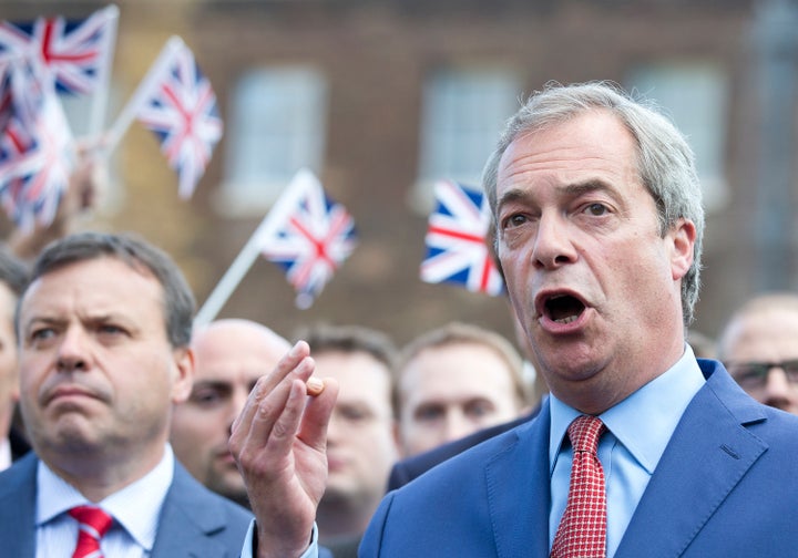 Nigel Farage, supported by Arron Banks (L), gives a press conference at College Green, Westminster, after UK votes to leave European Union.